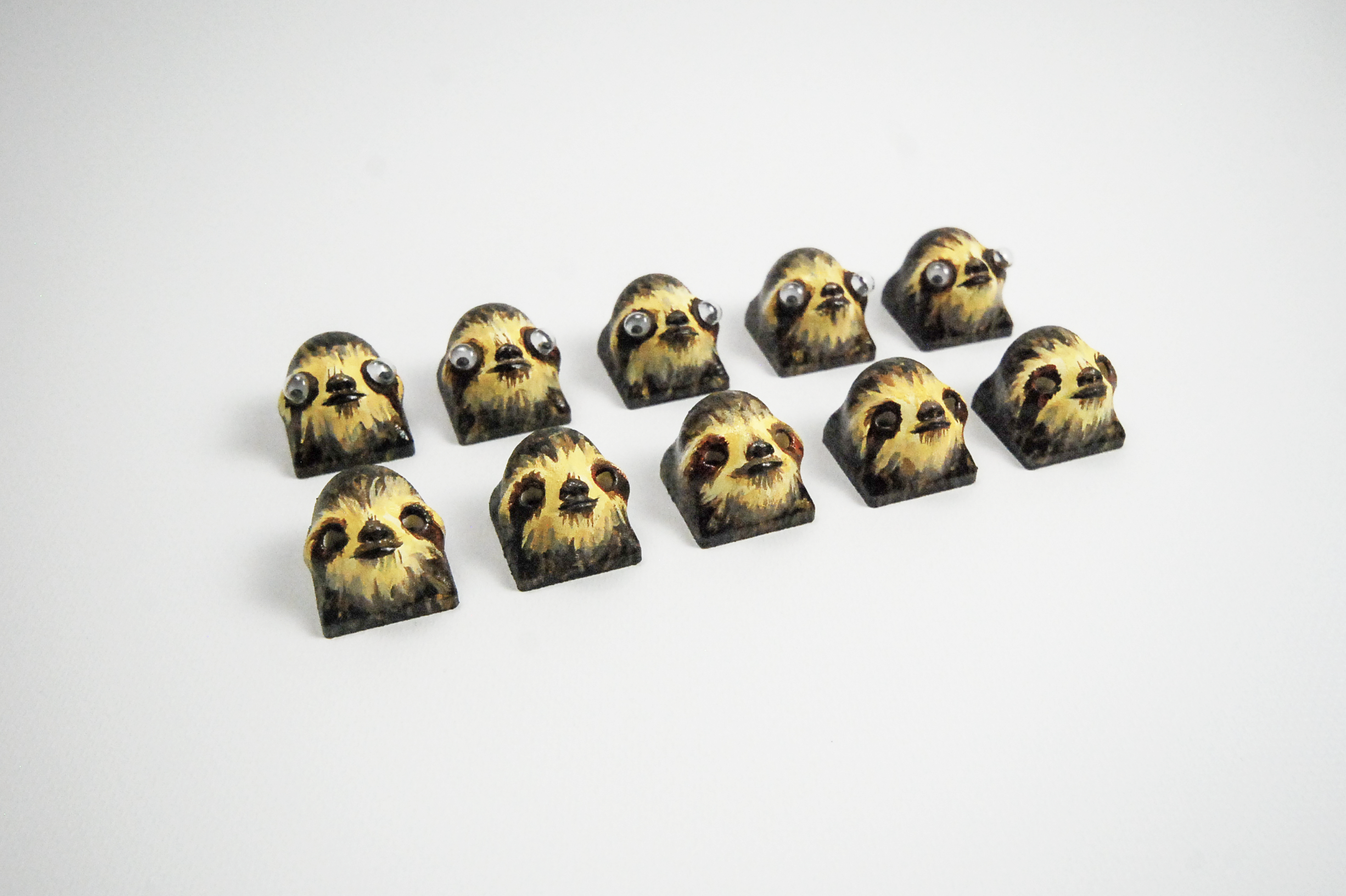 Sloth caps with and without googly eyes
